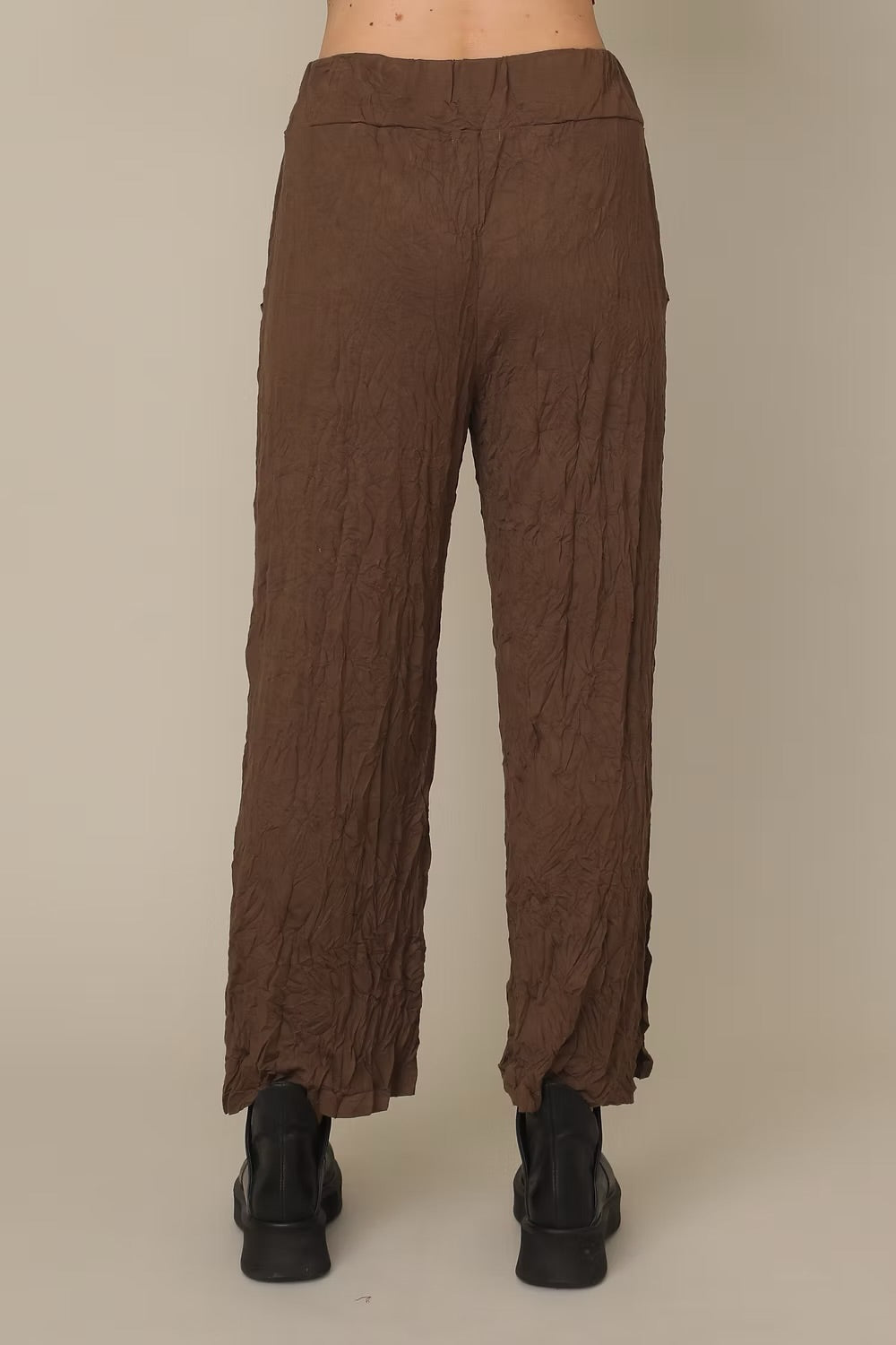 Brown textured pants on a beige background at Victoria Susan Wearable Art in Camden SC