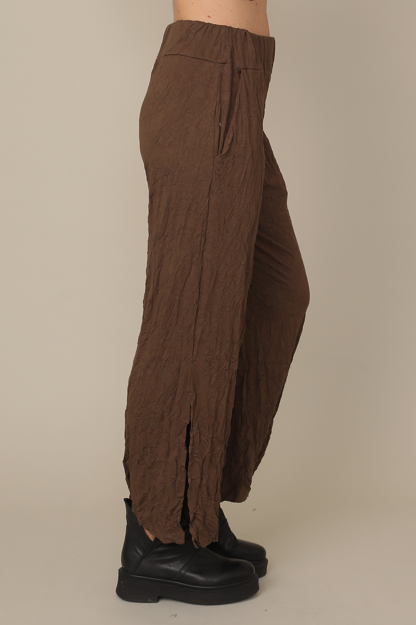Brown wide-leg pants worn by a person on a beige background Victoria Susan Wearable Art in Camden SC