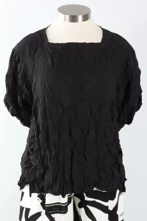 Black textured top on a mannequin with a white background at Victoria Susan in Camden SC