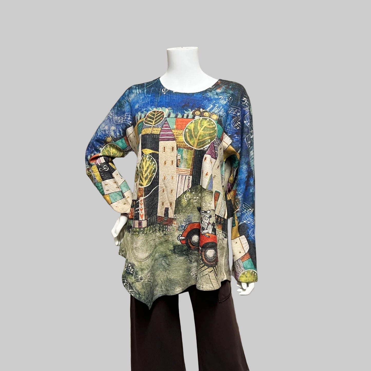 Colorful patterned shirt on a mannequin against a plain background