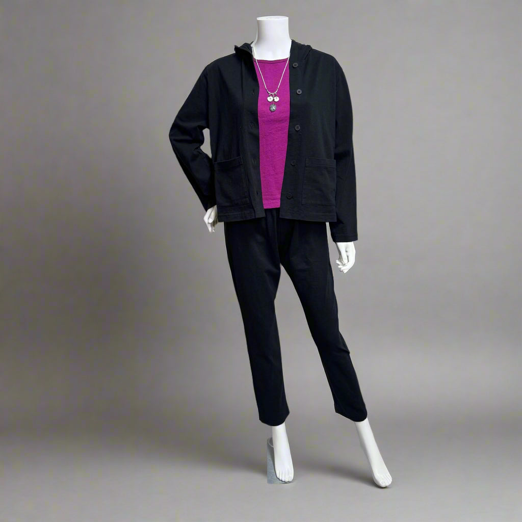 Mannequin wearing a black outfit with a pink top against a beige background at Victoria Susan in Camden SC. Shop women's clothing and wearable art.