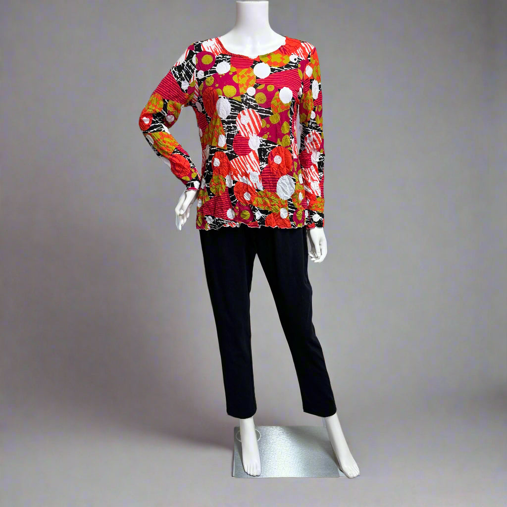 Mannequin at Victoria Susan wearing a colorful patterned top in peony by Chalet et Ceci and black pants in Camden SC. Shop wearable art and women's clothing in Camden SC