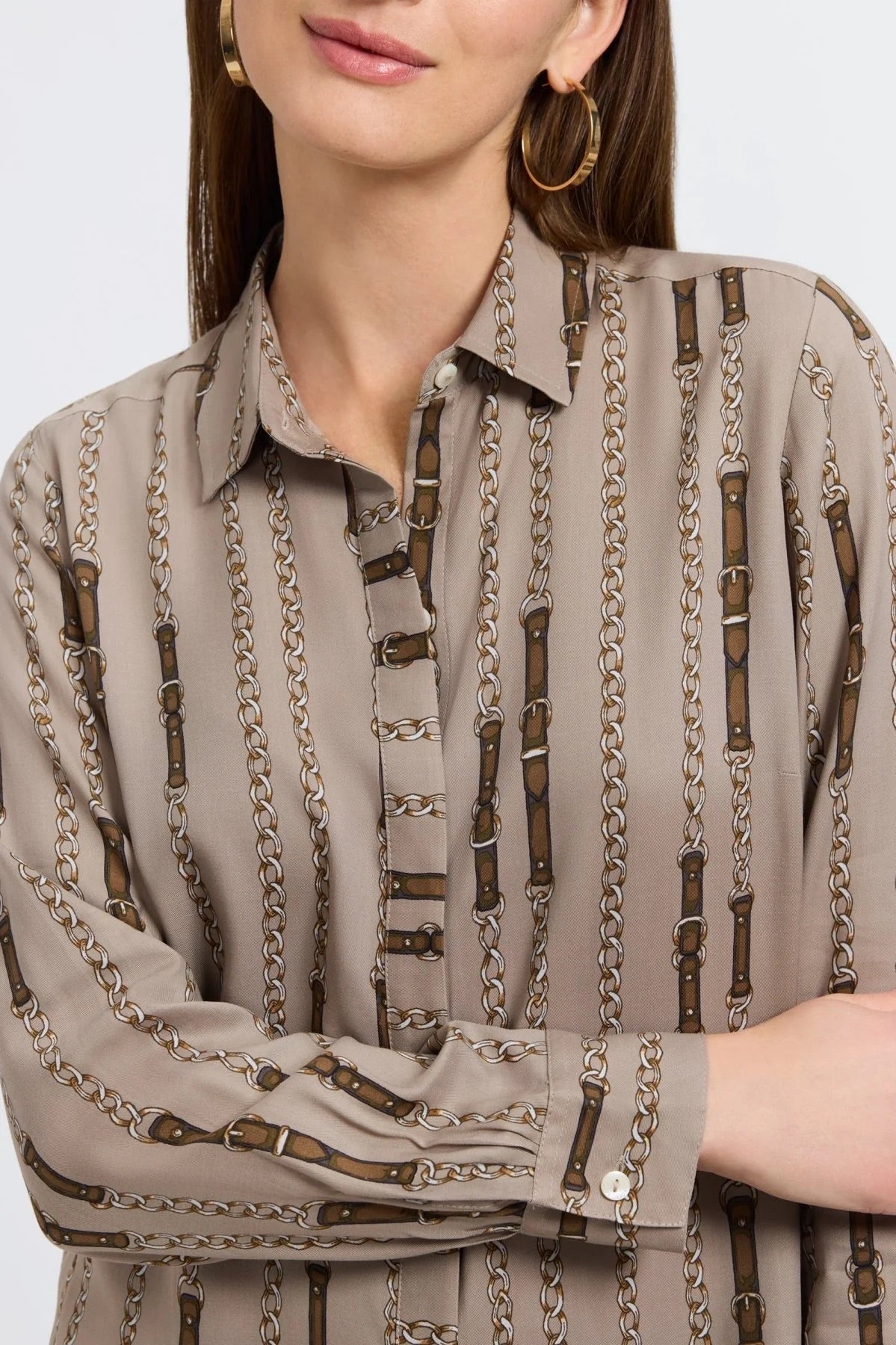Close-up of a Woman wearing a patterned blouse by Foxcroft against a plain background at Victoria Susan Wearable Art in Camden SC