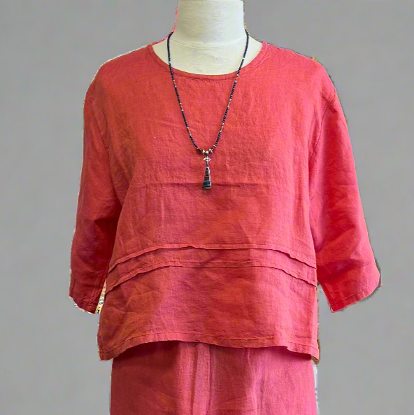Red outfit on a mannequin against a gray background