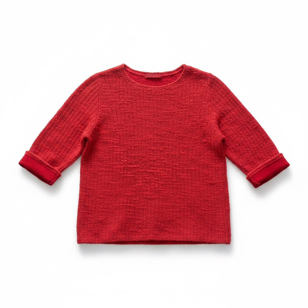 A red textured knit long-sleeve top with ribbed cuffs, shown flat against a white background.