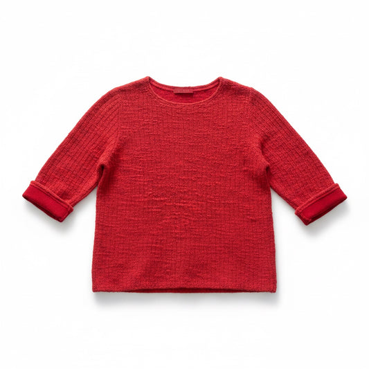 A red textured knit long-sleeve top with ribbed cuffs, shown flat against a white background.