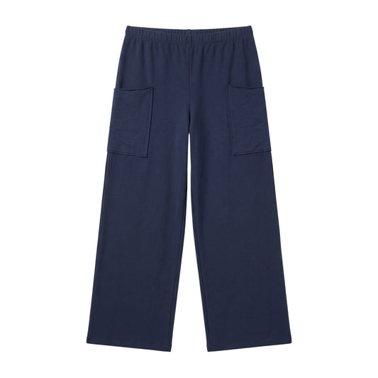 A pair of navy blue cotton pants  by Prairie Cotton with an elastic waistband and two large front patch pockets, shown flat against a white background. Nebula Raw Edge Full Pant is made in the USA