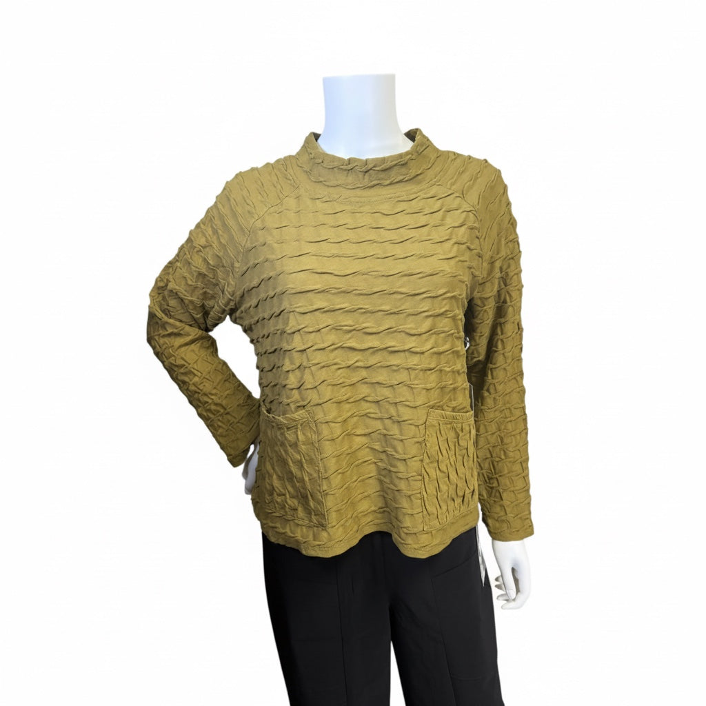 A textured, long-sleeve knit sweater in a muted olive-mustard color, displayed on a white mannequin torso with black trousers against a plain white background.