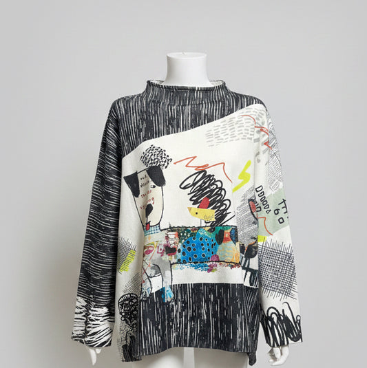 Mannequin wearing a colorful, abstract-patterned sweater against a beige wall.