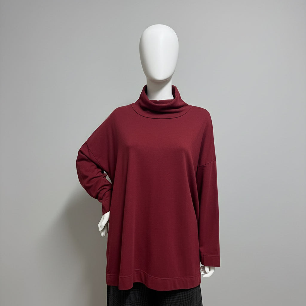 Maroon long-sleeve top on a mannequin against a beige background
