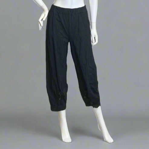 Black wide-leg pants on a mannequin against a gray background