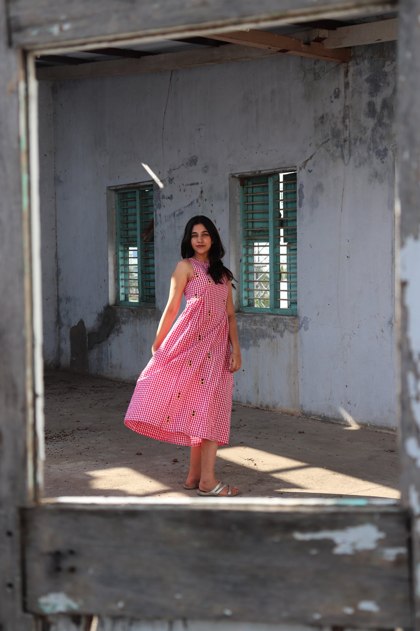 Mannequin wearing a red sweater and black pants against a plain background at Victoria Susan in Camden SC