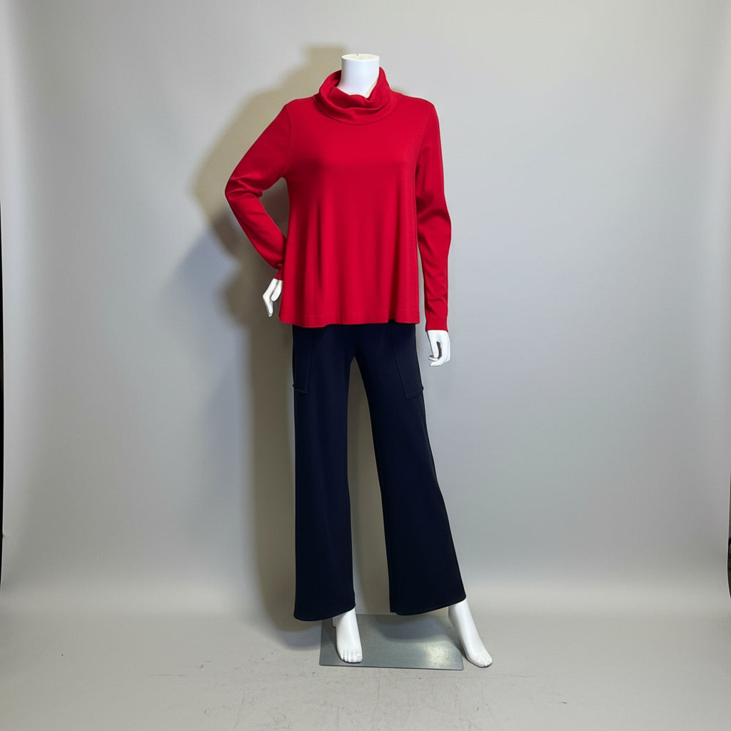 Mannequin wearing a red sweater and black pants against a plain background at Victoria Susan in Camden SC