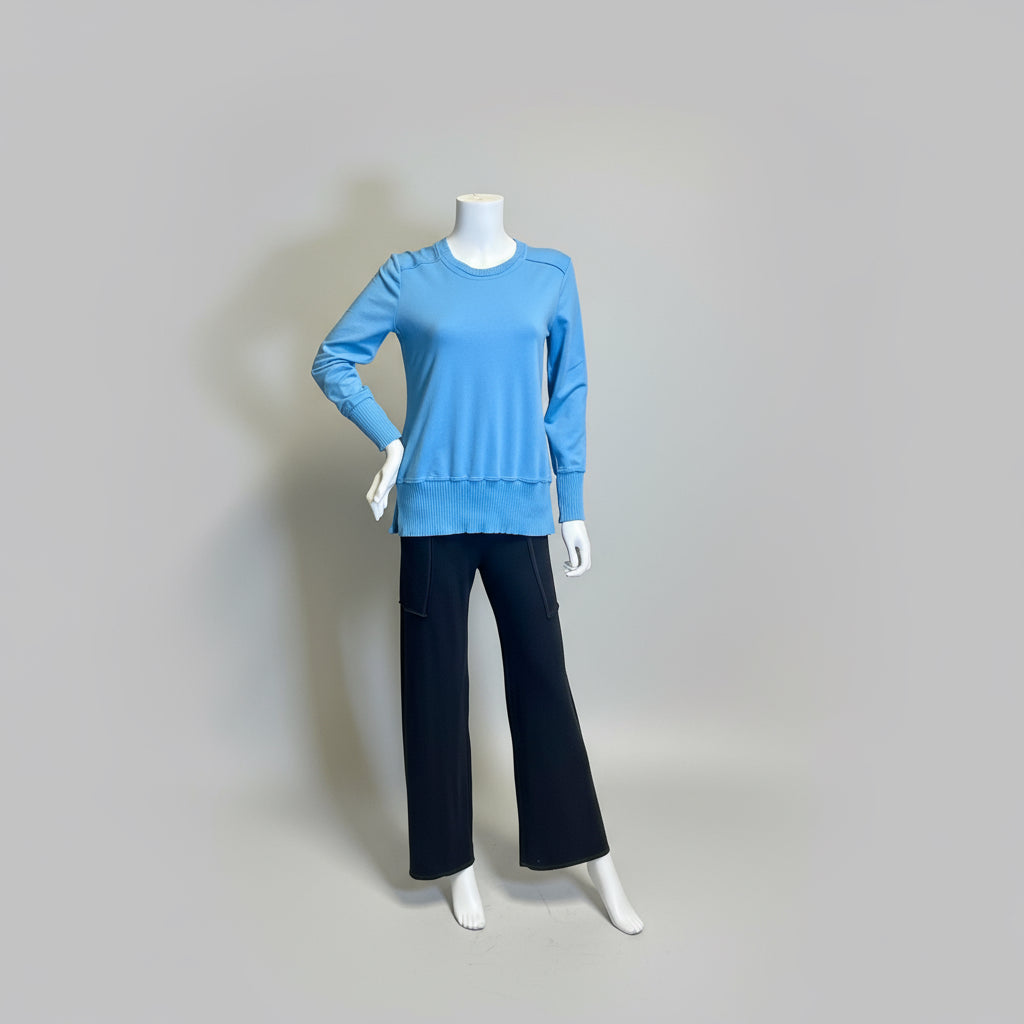 Mannequin wearing a blue sweater and black pants against a plain background at Victoria Susan in Camden SC