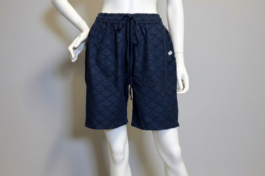 Navy blue patterned shorts on a mannequin against a beige background at Victoria Susan in Camden, SC
