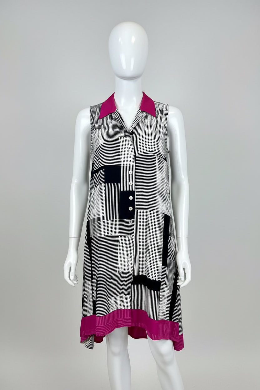Plaid dress with pink accents on a mannequin against a beige background