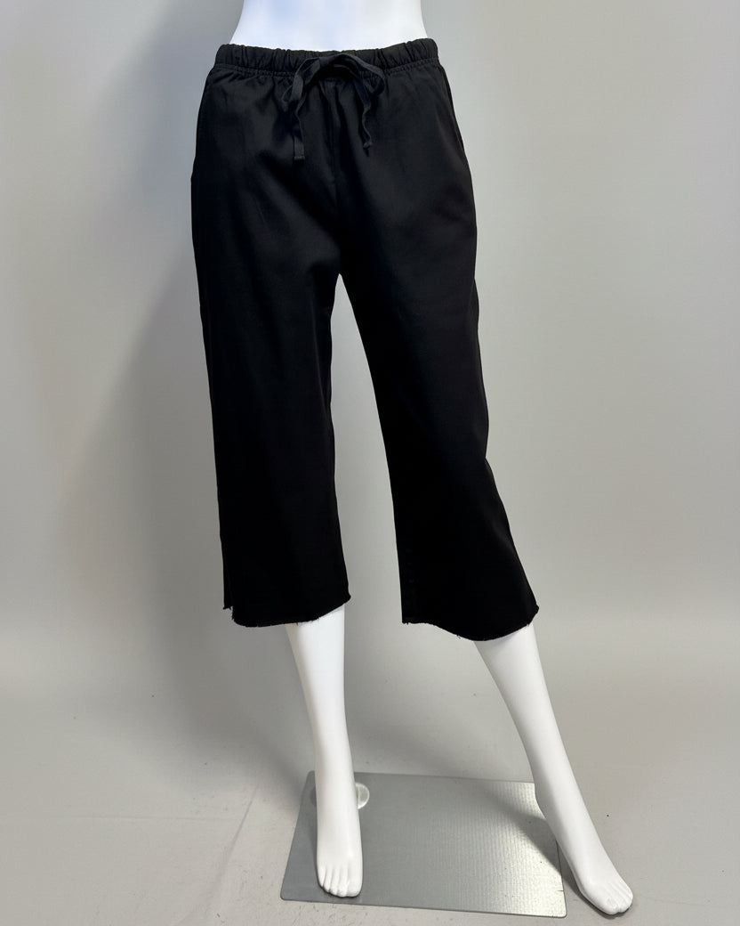 Black pants on a mannequin against a beige background
