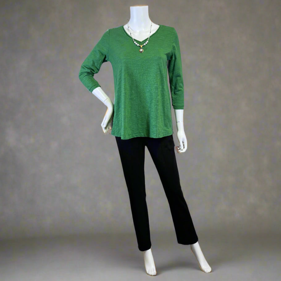 Mannequin wearing a green Tee by Kleen and black pants by Habitat against a neutral background. Shop women's clothing and wearable art at Victoria Susan in Camden, SC