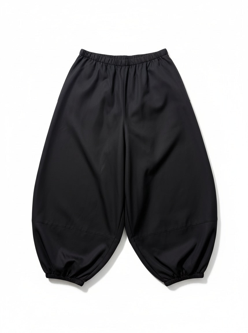 Black elastic-waist harem-style pants with gathered cuffed hems, photographed flat against a white background.