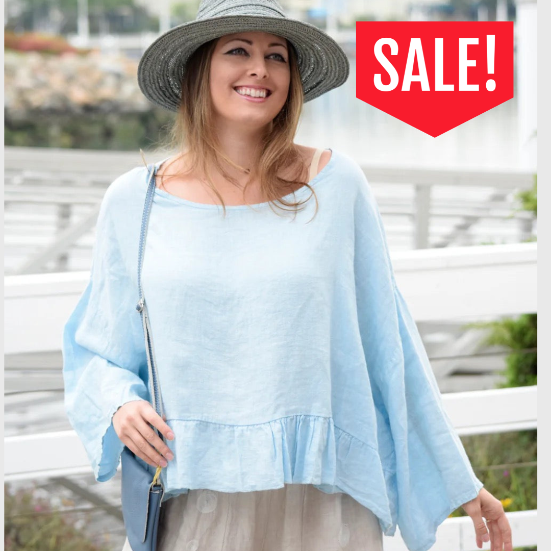 Woman wearing a light blue top and gray hat with a 'SALE!' sign in the corner.